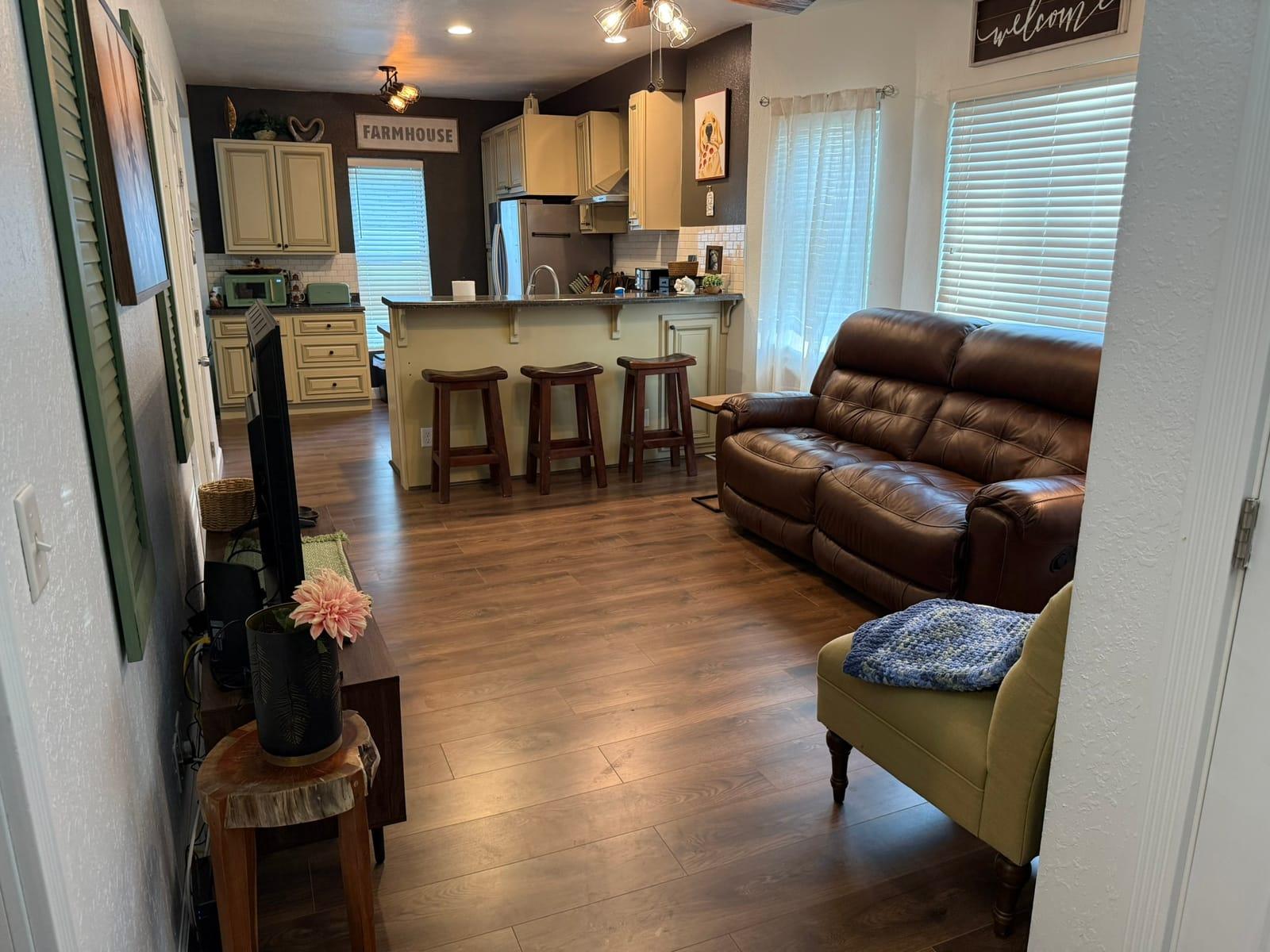 A bright, furnished living room in a Rose’s Village stay